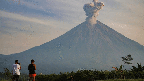 Wisatawan mengabadikan gambar asap vulkanis keluar dari kawah Gunung Semeru terlihat dari Kecamatan Pronojiwo, Lumajang, Jawa Timur, Rabu (8/10/2025). ANTARA FOTO/Irfan Sumanjaya